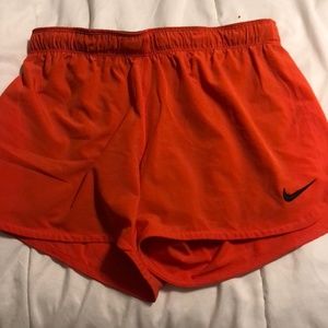 Orange Nike shorts. Size medium